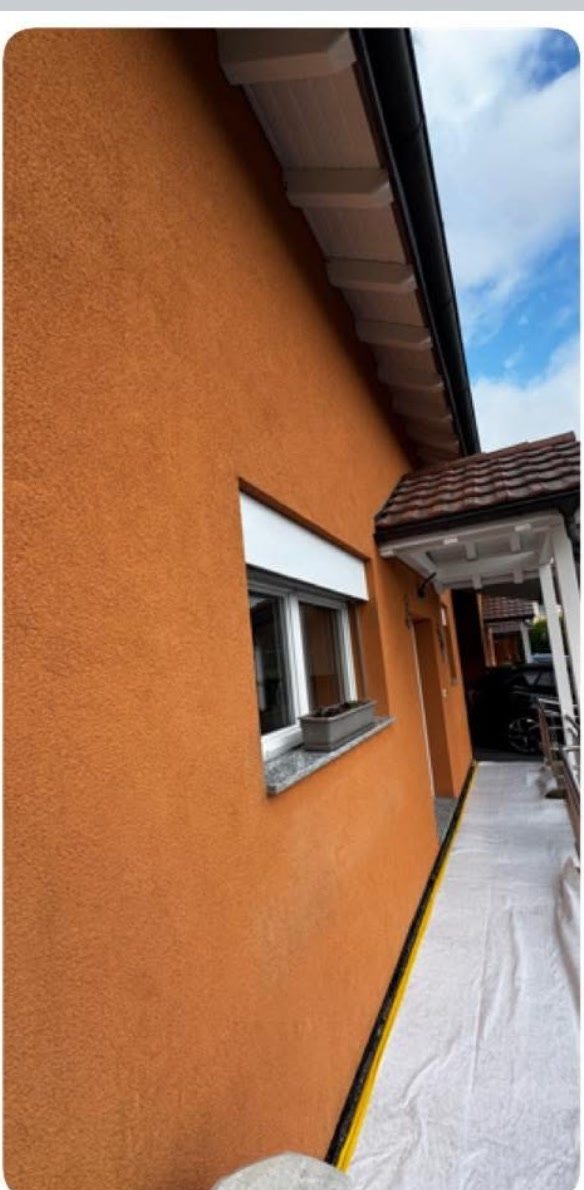 Façade après intervention MNPro — finition gris taupe